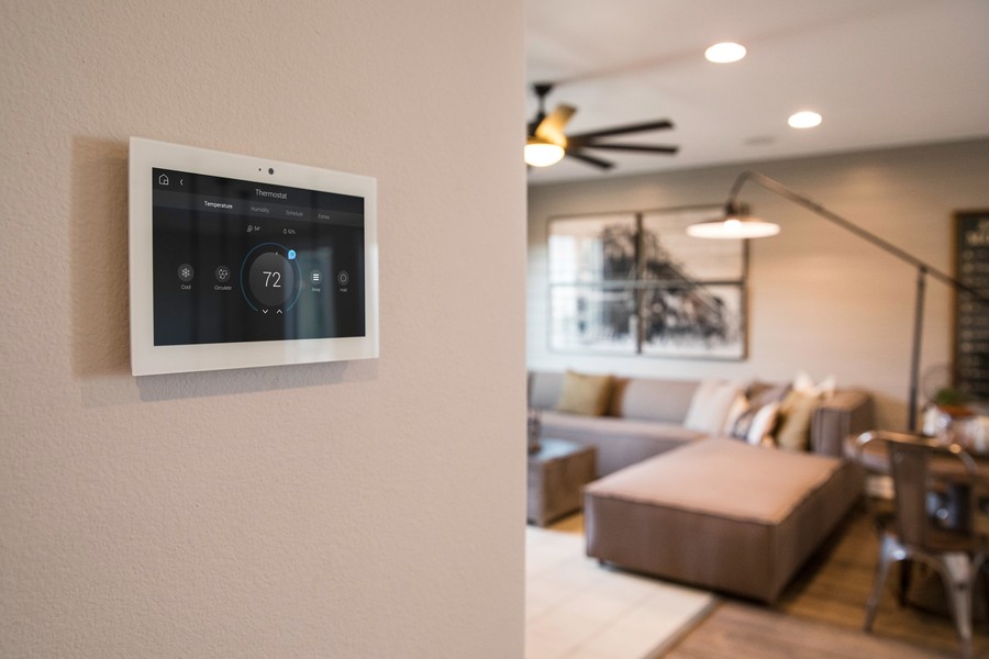 Wall tablet displays Control4 climate control in a living room. The temperature is set to 72 degrees.  