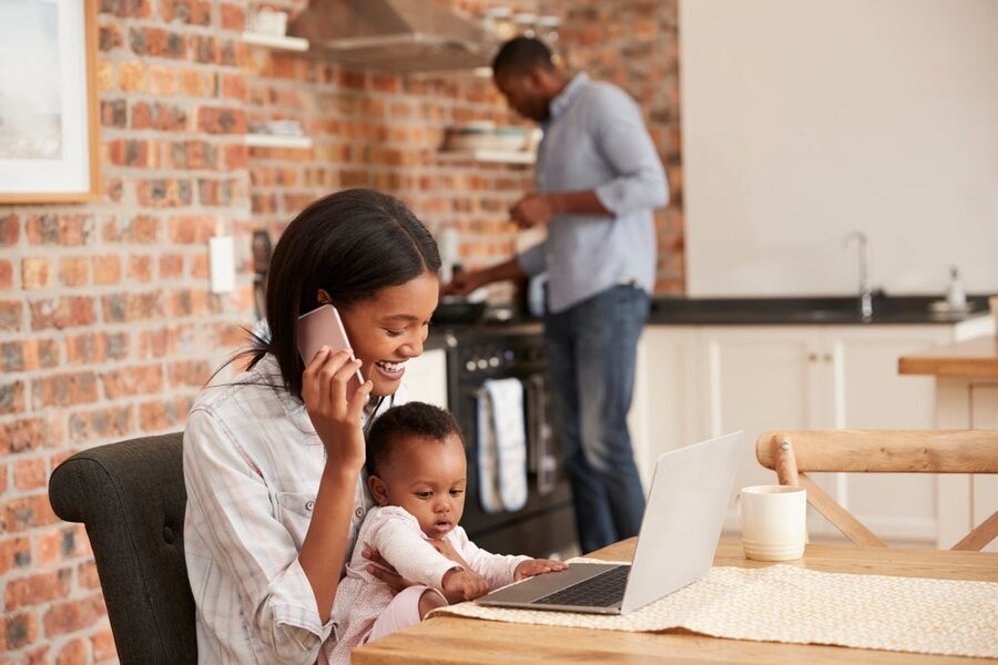 A family in their kitchen utilizing various smart devices via a smart home network setup.